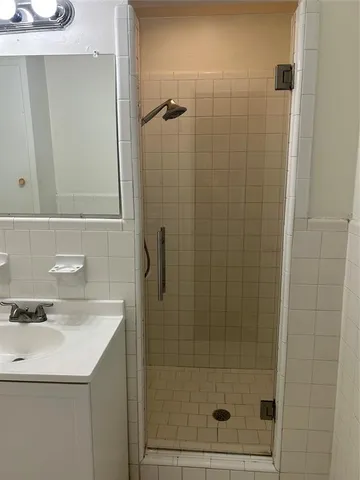 a bathroom with a shower and sink