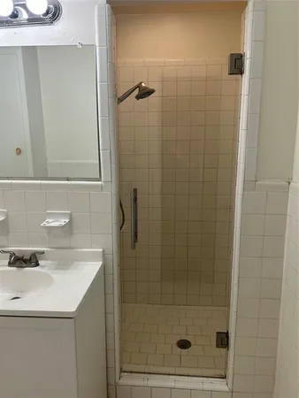 a bathroom with a shower and sink