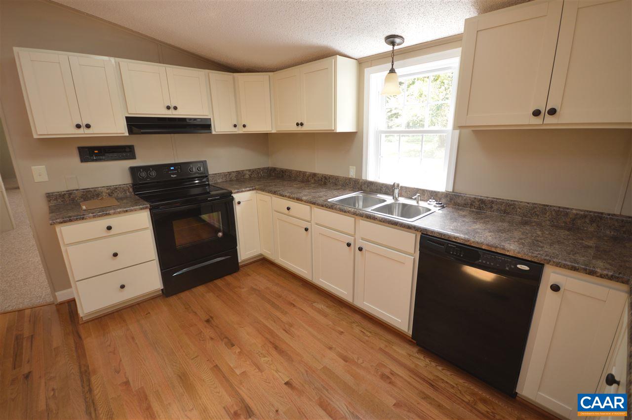 4439 Amicus Road Ruckersville, VA 22968 - Photo 8 of 47 a kitchen with granite countertop a sink cabinets and stainless steel appliances