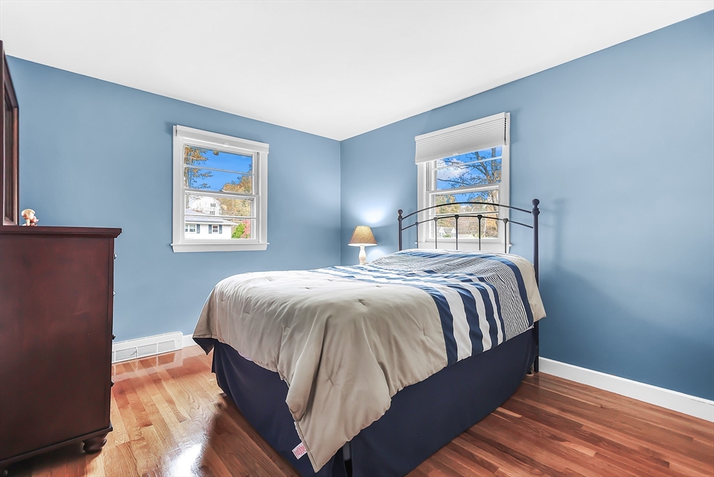 86 Butternut Lane Methuen, MA 01844 - Photo 20 of 32 a bedroom with a bed and wooden floor