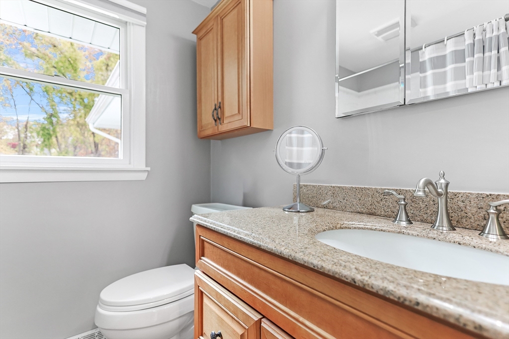 86 Butternut Lane Methuen, MA 01844 - Photo 24 of 32 a bathroom with a granite countertop toilet sink and mirror