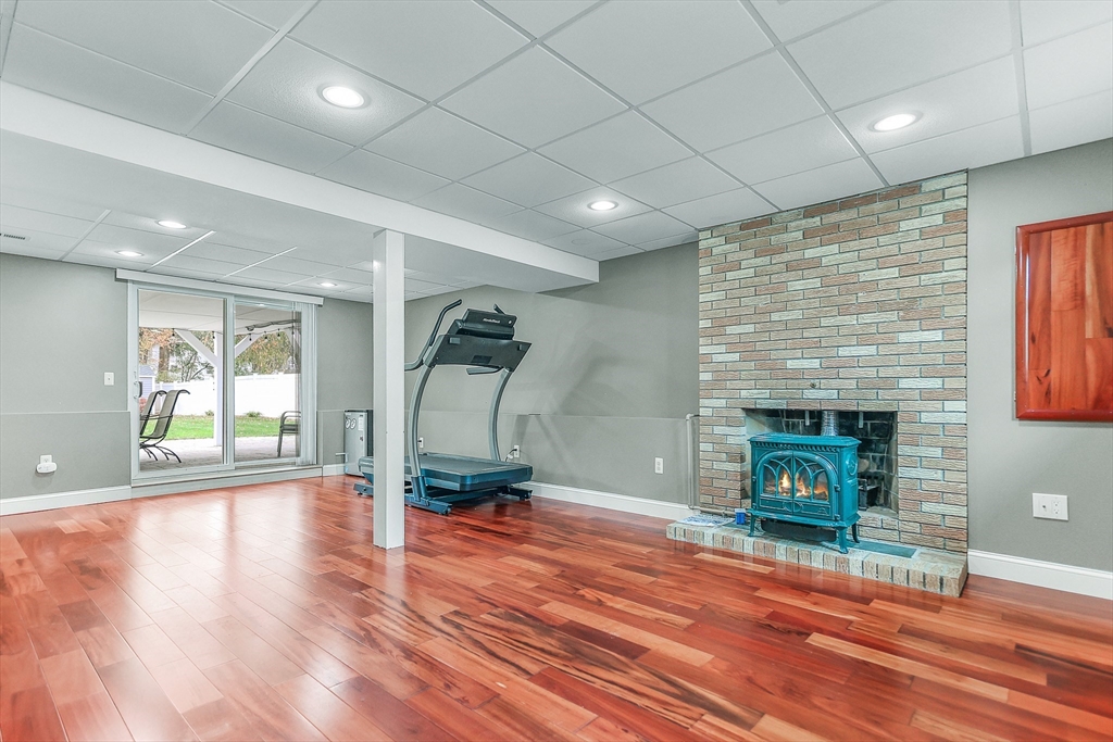 86 Butternut Lane Methuen, MA 01844 - Photo 26 of 32 a living room with fireplace furniture and a wooden floor