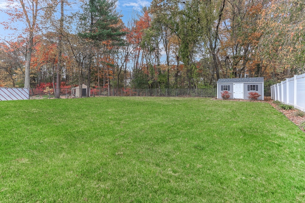 86 Butternut Lane Methuen, MA 01844 - Photo 27 of 32 a view of a big yard with large trees