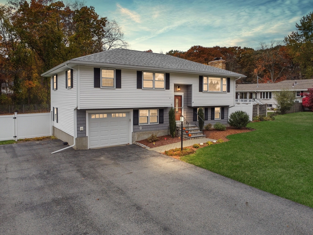 86 Butternut Lane Methuen, MA 01844 - Photo 29 of 32 a front view of a house with a yard and garage