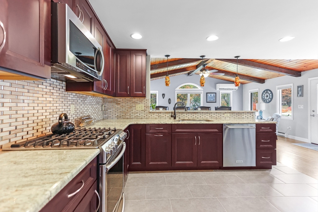 86 Butternut Lane Methuen, MA 01844 - Photo 9 of 32 a kitchen with a stove a sink and a microwave