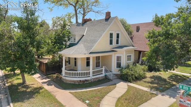 a front view of a house with a yard garage and outdoor seating