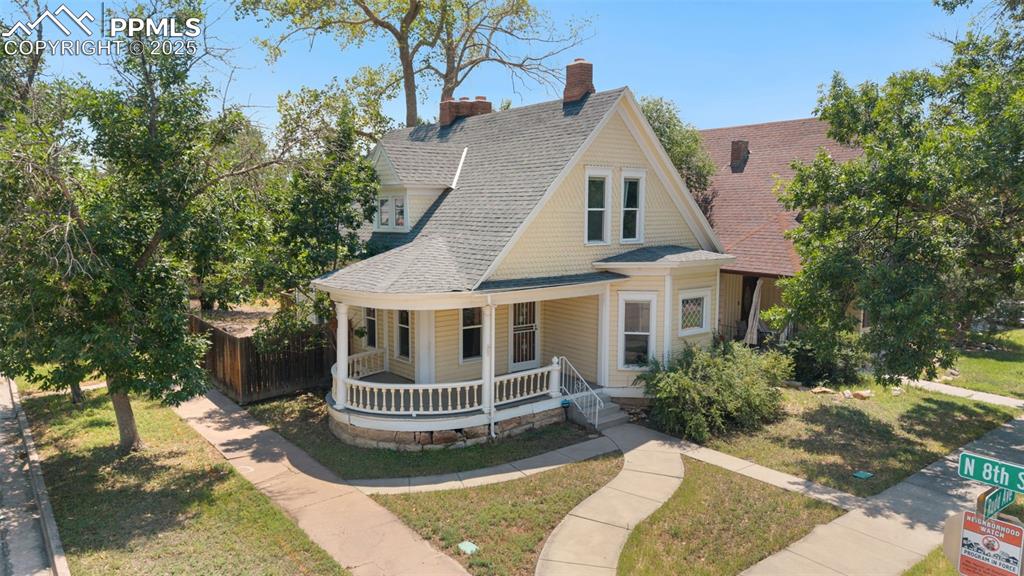 a front view of a house with a yard garage and outdoor seating
