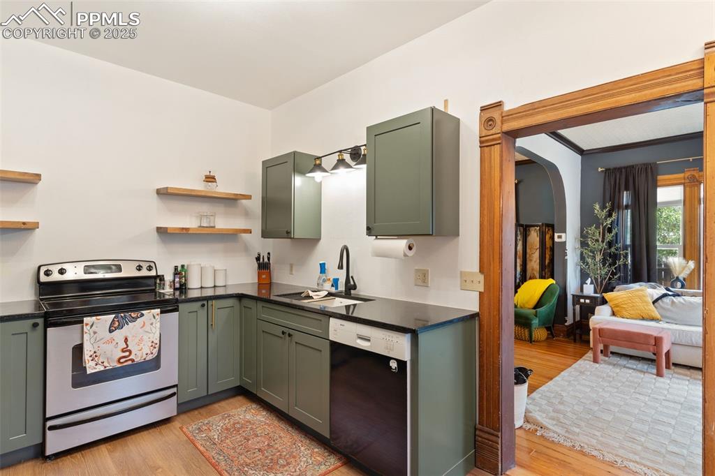 732 Rudd Avenue Canon City, CO 81212 - Photo 16 of 36 a kitchen with stainless steel appliances granite countertop a sink and stove top oven