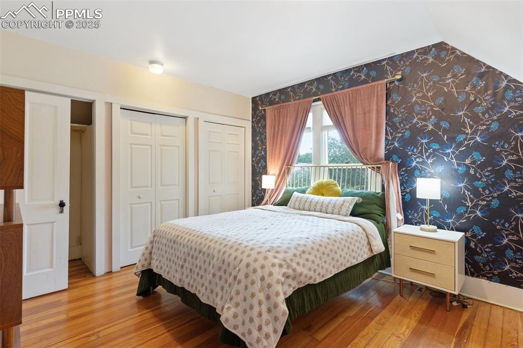 732 Rudd Avenue Canon City, CO 81212 - Photo 25 of 36 a bedroom with a bed and wooden floor