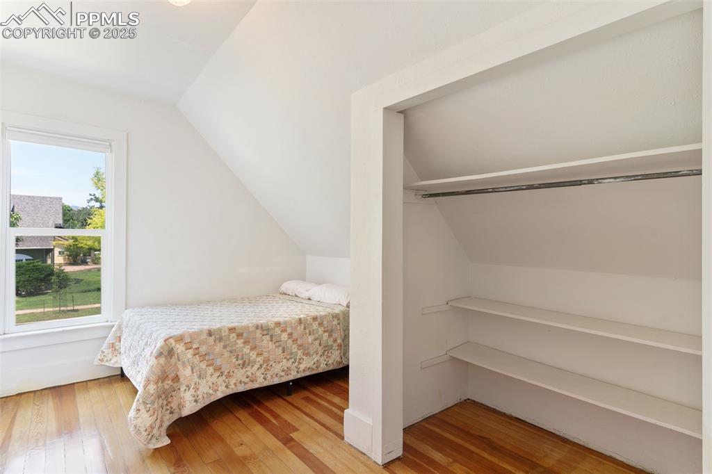 732 Rudd Avenue Canon City, CO 81212 - Photo 26 of 36 a bedroom with a bed and a window with wooden floor