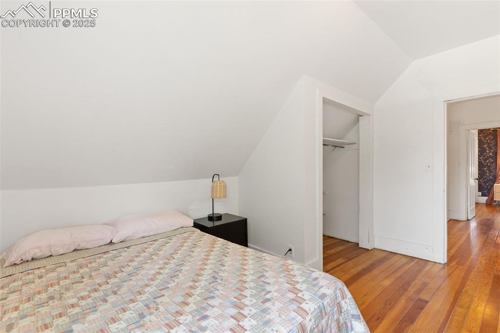 732 Rudd Avenue Canon City, CO 81212 - Photo 27 of 36 a bedroom with a bed and wooden floor