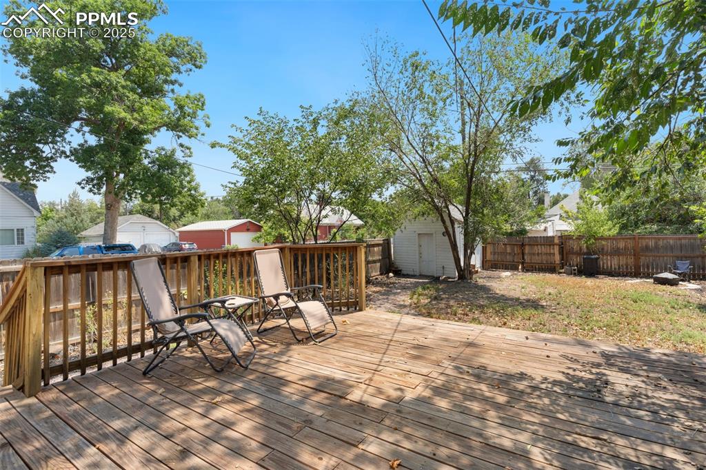 732 Rudd Avenue Canon City, CO 81212 - Photo 33 of 36 a view of a wooden deck with chairs and a yard