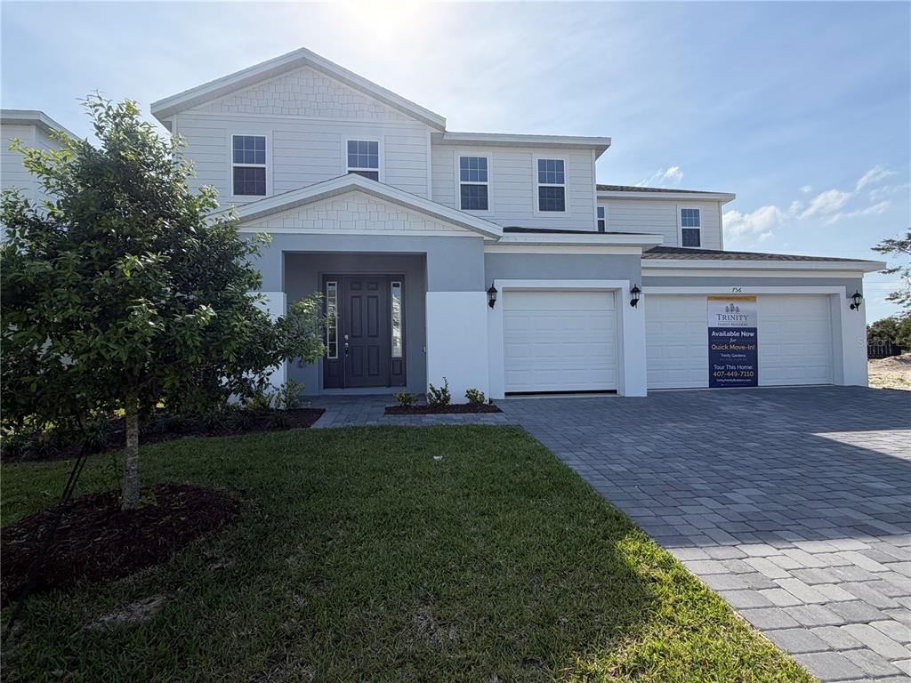 756 Farfields Street DeLand, FL 32724 - Photo 1 of 13 a front view of a house with a yard and garage