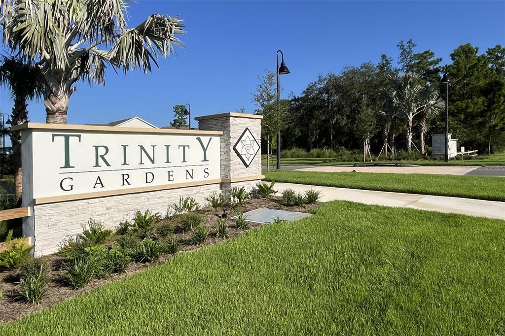 756 Farfields Street DeLand, FL 32724 - Photo 12 of 13 a sign of golf club on a wall under a tree