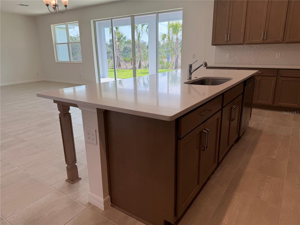 756 Farfields Street DeLand, FL 32724 - Photo 6 of 13 a kitchen with stainless steel appliances granite countertop a sink stove and refrigerator