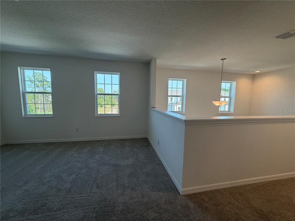 756 Farfields Street DeLand, FL 32724 - Photo 7 of 13 an empty room with windows and closet
