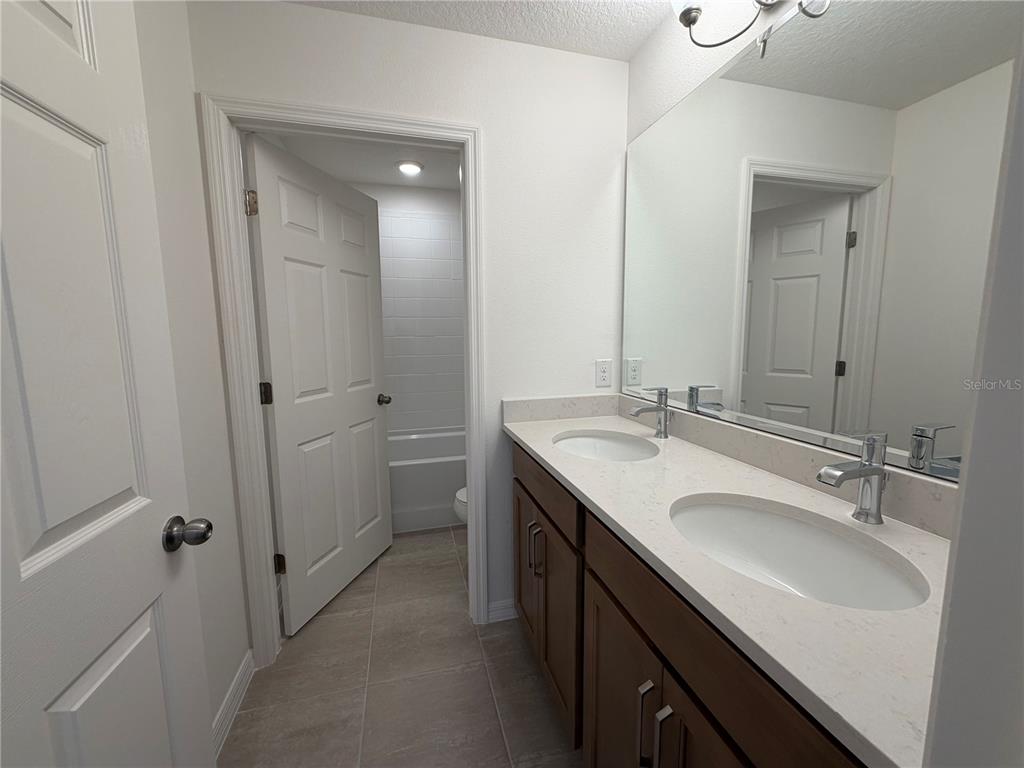 756 Farfields Street DeLand, FL 32724 - Photo 8 of 13 a bathroom with a sink double vanity and a mirror