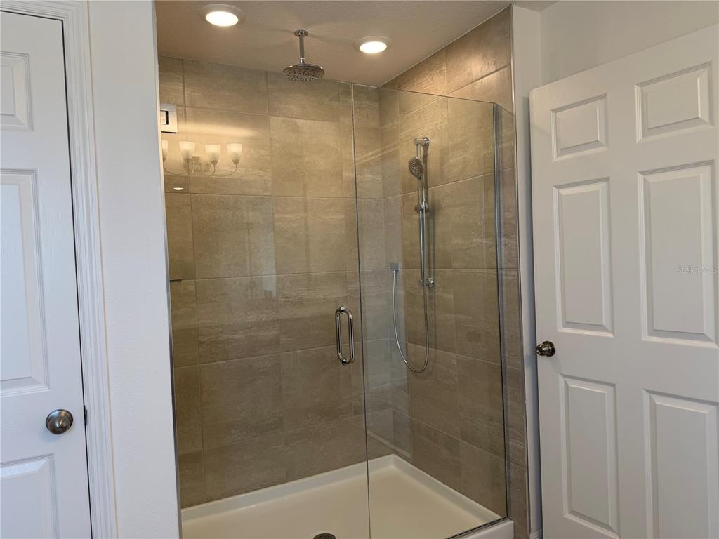 756 Farfields Street DeLand, FL 32724 - Photo 9 of 13 a bathroom with a shower and a glass door