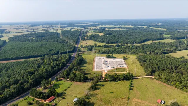 an aerial view of residential houses with outdoor space and lake view