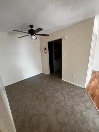 a view of a big room with a ceiling fan