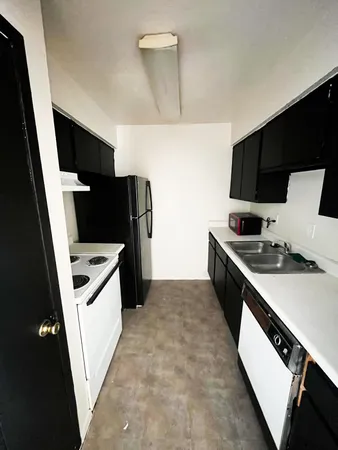 a kitchen with stainless steel appliances a stove microwave and a refrigerator