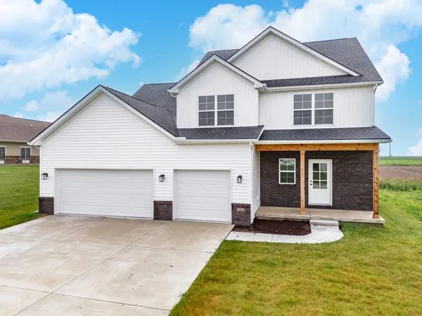 a front view of a house with a yard and garage