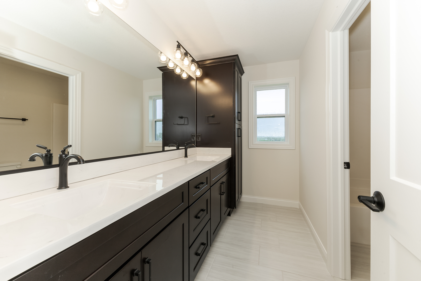 1313 Woodbine Road Bloomington, IL 61704 - Photo 13 of 67 a bathroom with a double vanity sink and mirror