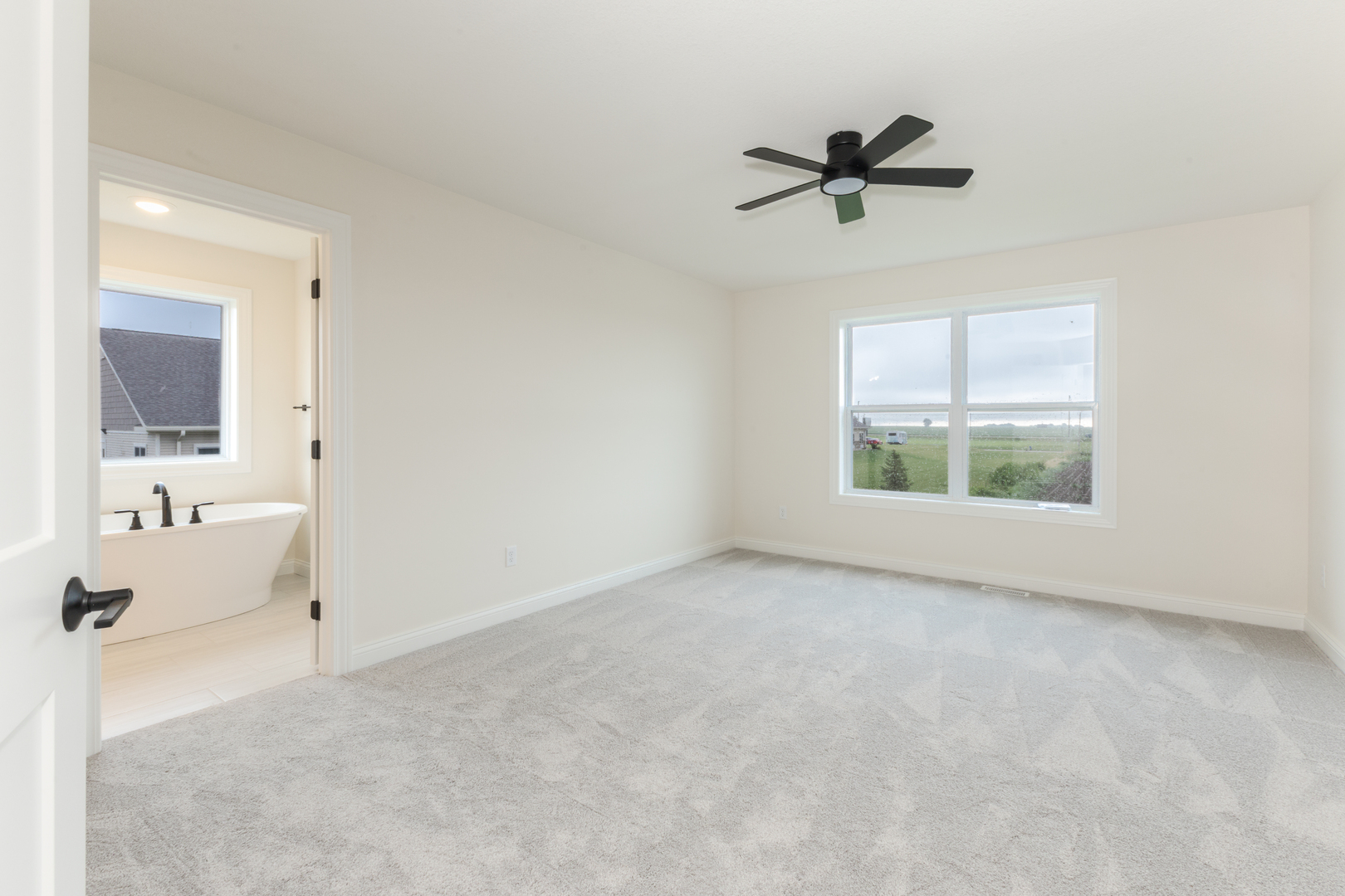 1313 Woodbine Road Bloomington, IL 61704 - Photo 20 of 67 a view of a livingroom with a ceiling fan and window