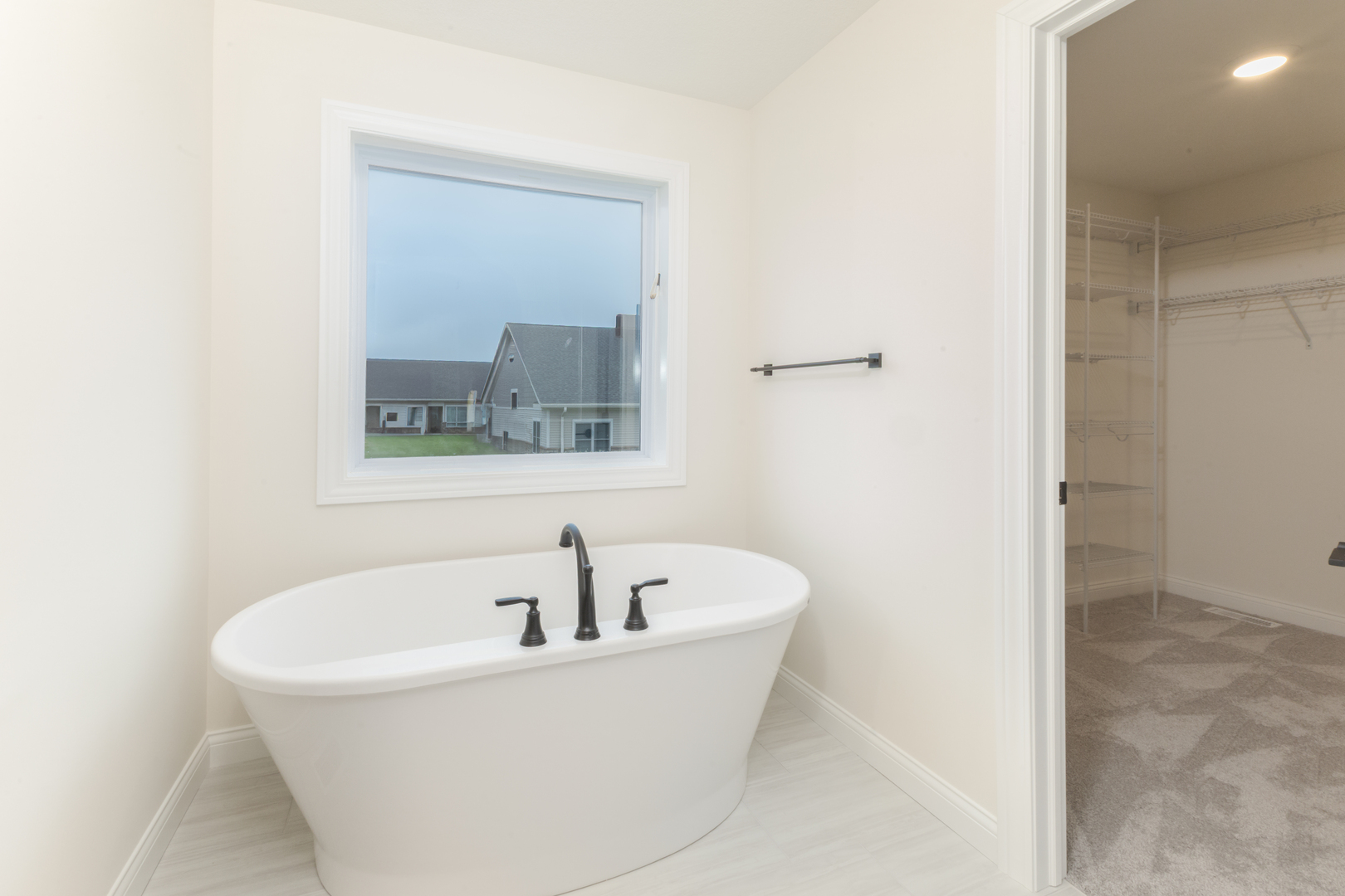 1313 Woodbine Road Bloomington, IL 61704 - Photo 22 of 67 a white bath tub sitting next to a white sink