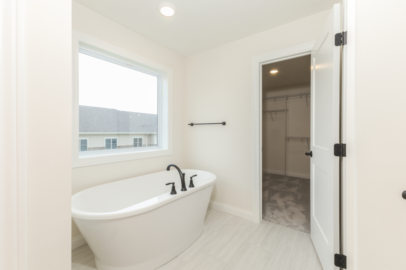 1313 Woodbine Road Bloomington, IL 61704 - Photo 24 of 67 a white bath tub sitting next to a window