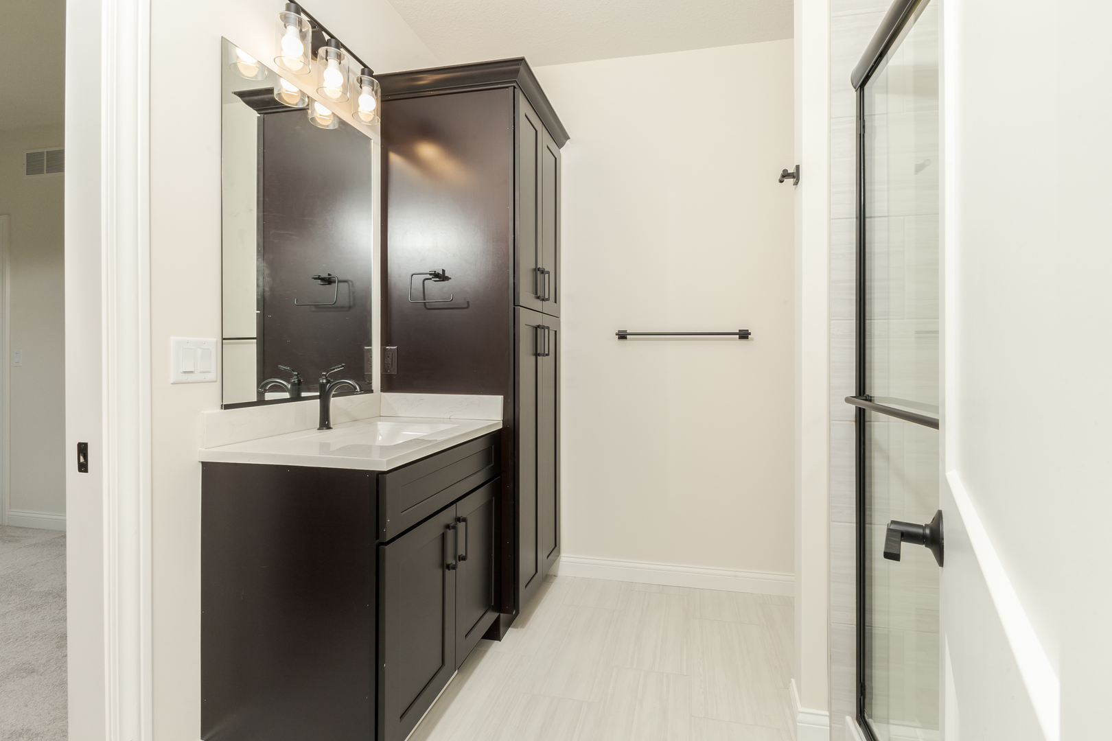 1313 Woodbine Road Bloomington, IL 61704 - Photo 32 of 67 a bathroom with a sink and mirror with shower