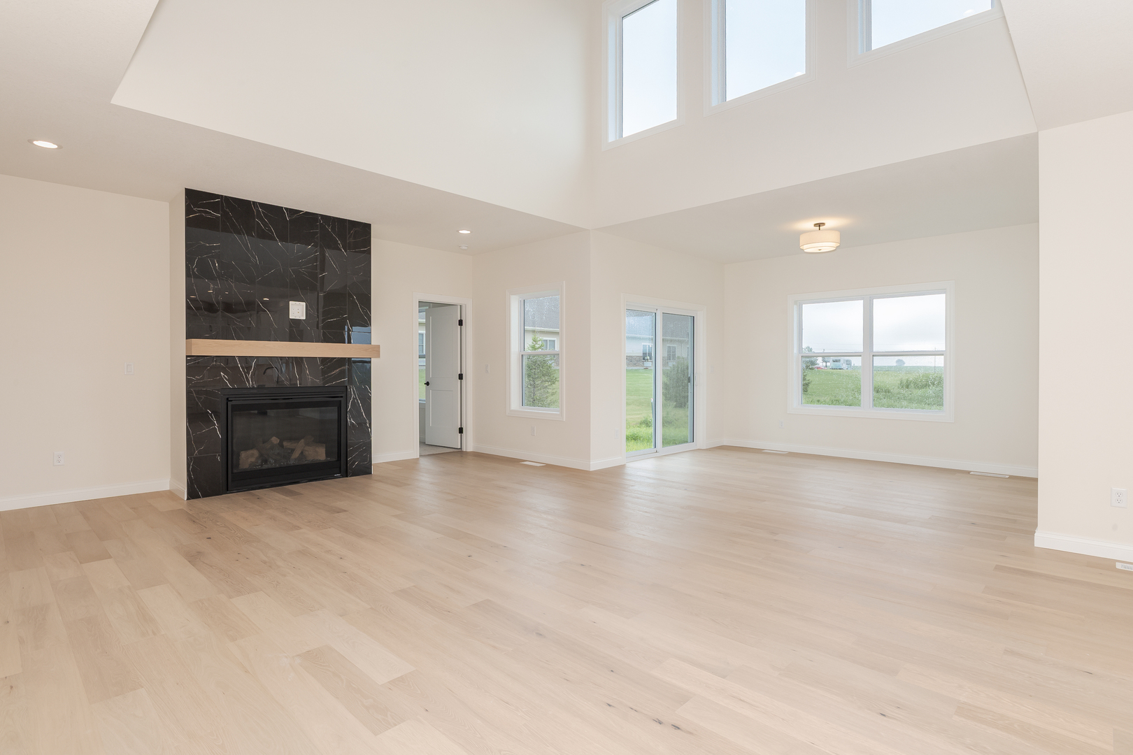 1313 Woodbine Road Bloomington, IL 61704 - Photo 40 of 67 an empty room with windows and fireplace