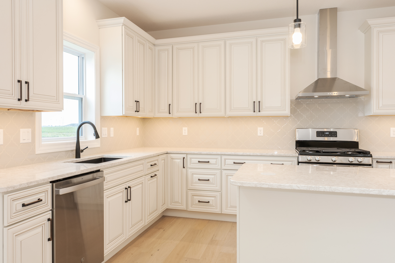 1313 Woodbine Road Bloomington, IL 61704 - Photo 43 of 67 a kitchen with stainless steel appliances granite countertop a sink dishwasher a stove and white cabinets with wooden floor