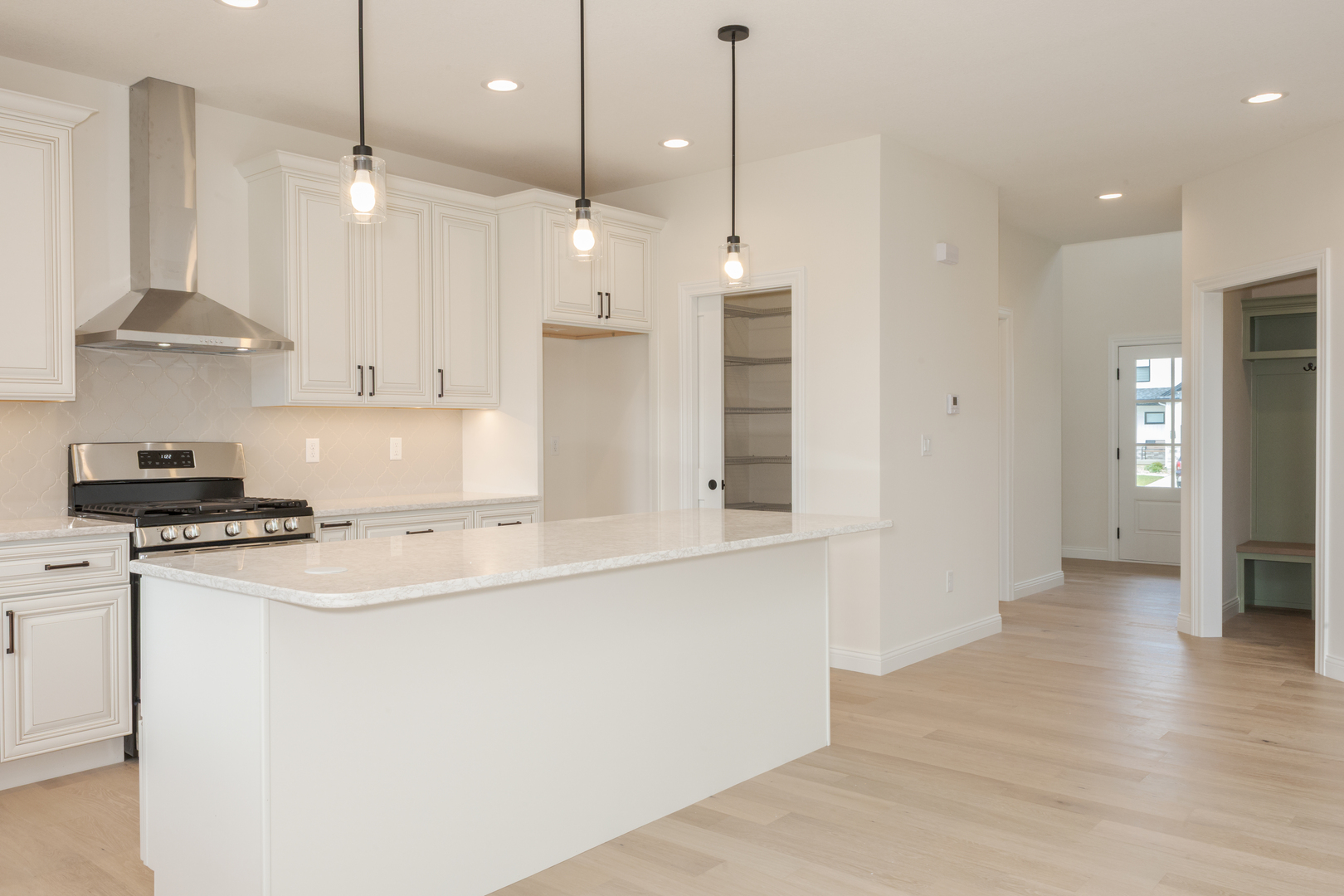 1313 Woodbine Road Bloomington, IL 61704 - Photo 45 of 67 a kitchen with stainless steel appliances granite countertop a sink a stove a refrigerator and white cabinets with wooden floor