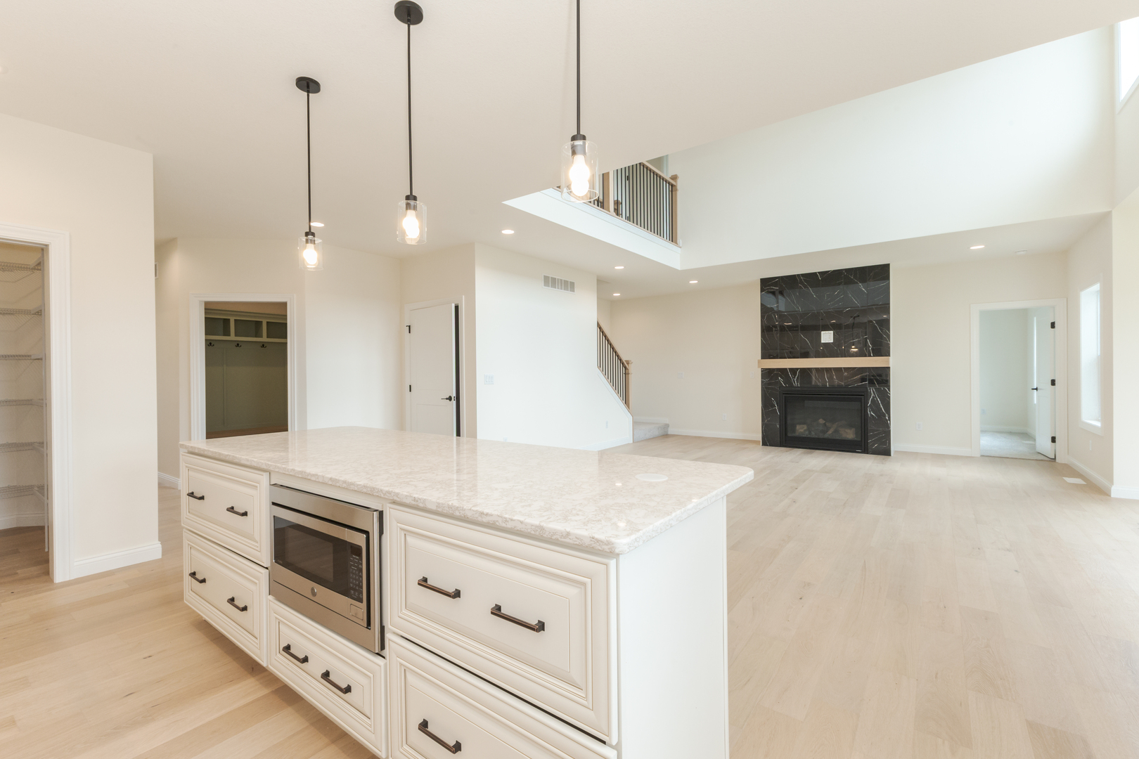 1313 Woodbine Road Bloomington, IL 61704 - Photo 46 of 67 a kitchen with stainless steel appliances white cabinets and a wooden floor