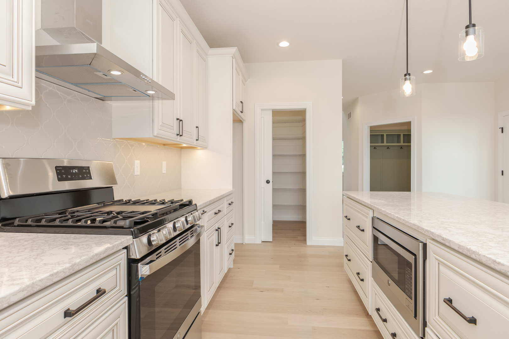 1313 Woodbine Road Bloomington, IL 61704 - Photo 47 of 67 a kitchen with stainless steel appliances a stove a sink and a refrigerator