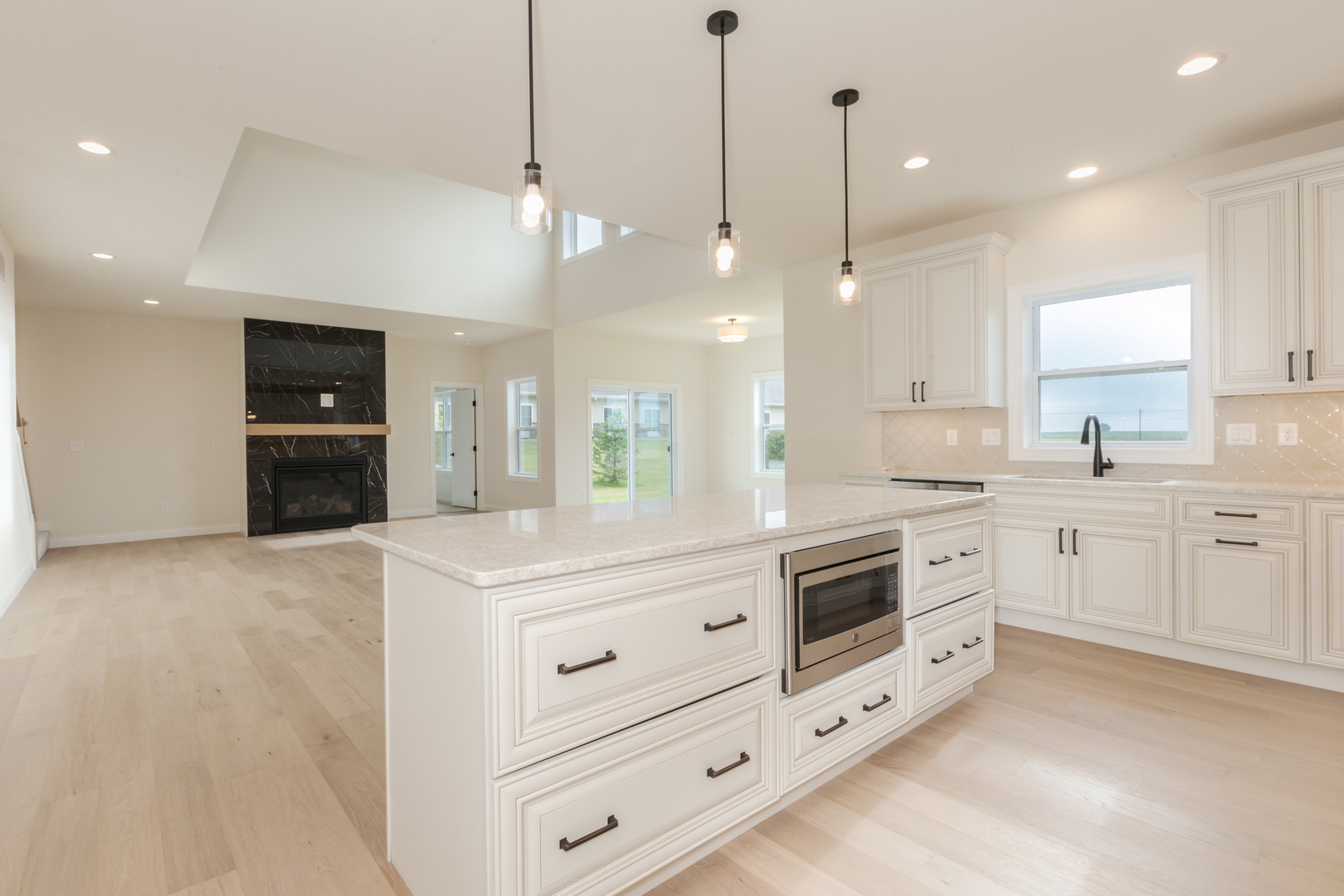 1313 Woodbine Road Bloomington, IL 61704 - Photo 49 of 67 a kitchen with white cabinets and white appliances