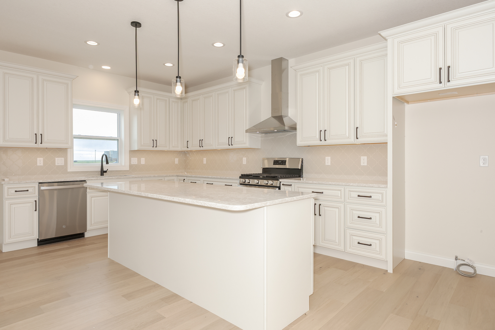 1313 Woodbine Road Bloomington, IL 61704 - Photo 51 of 67 a kitchen with kitchen island a stove a sink and a refrigerator