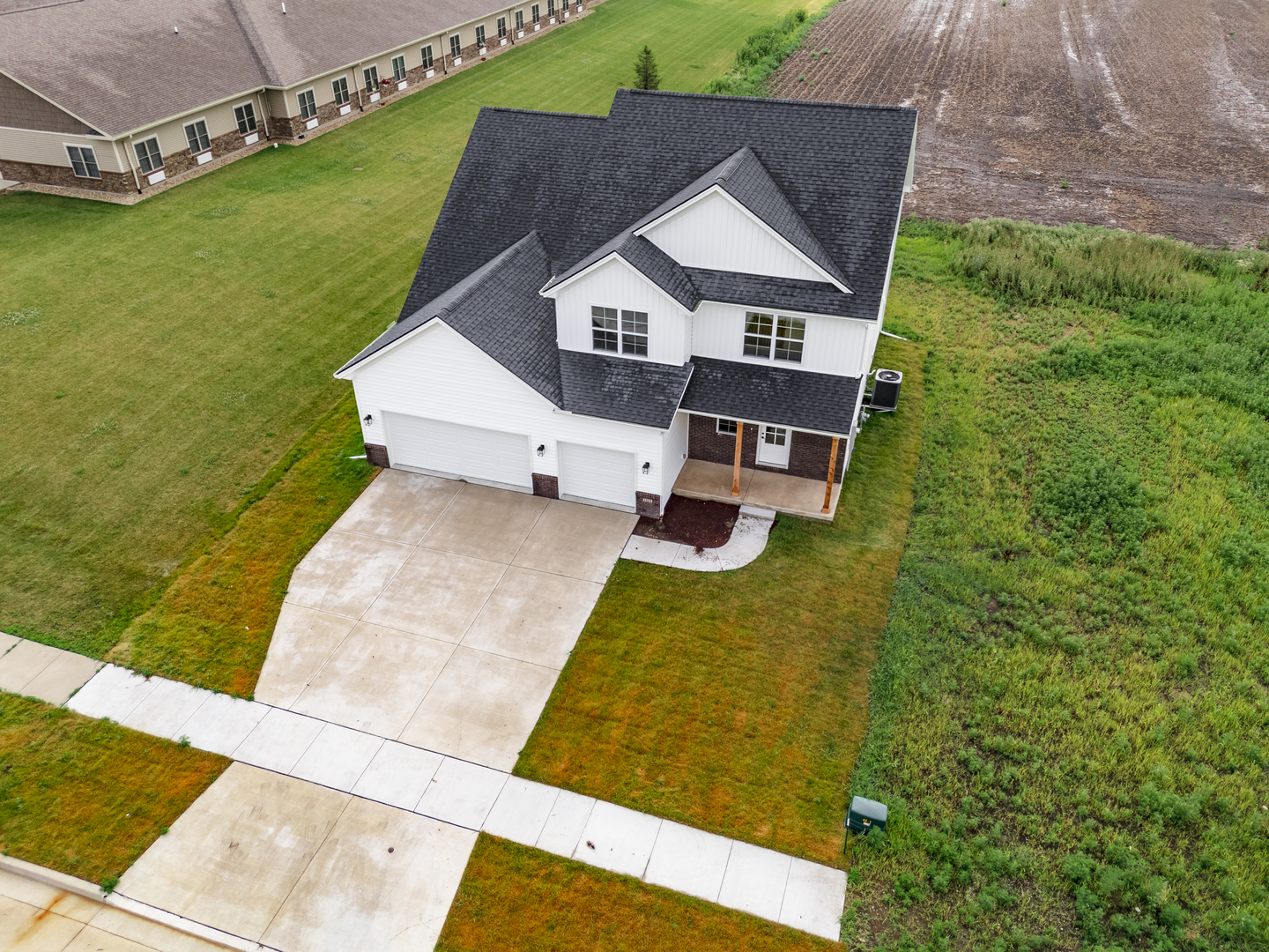 1313 Woodbine Road Bloomington, IL 61704 - Photo 52 of 67 a aerial view of a house with a yard