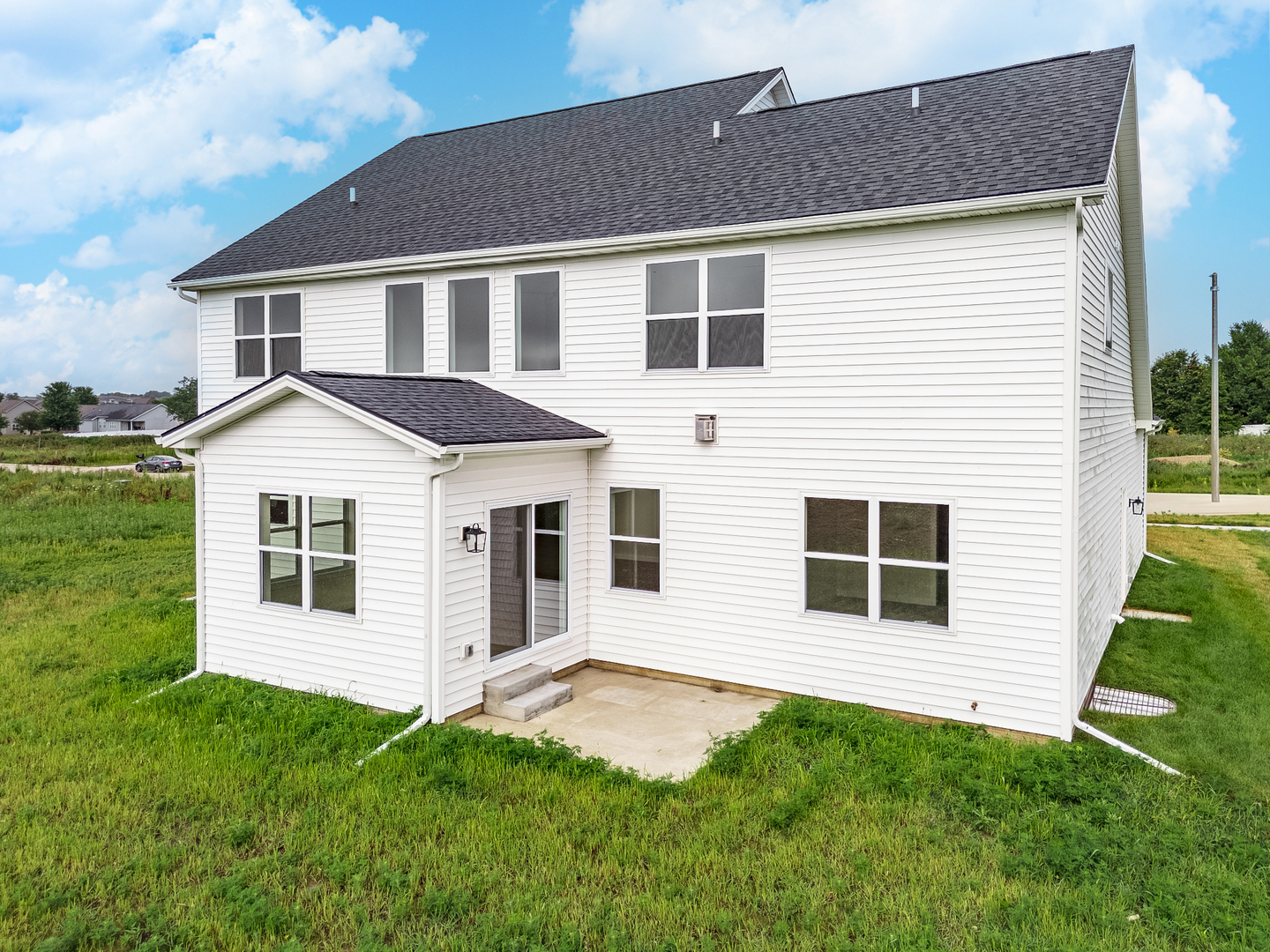 1313 Woodbine Road Bloomington, IL 61704 - Photo 55 of 67 a front view of a house with a yard