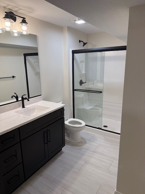 1313 Woodbine Road Bloomington, IL 61704 - Photo 67 of 67 a bathroom with a double vanity sink toilet and mirror