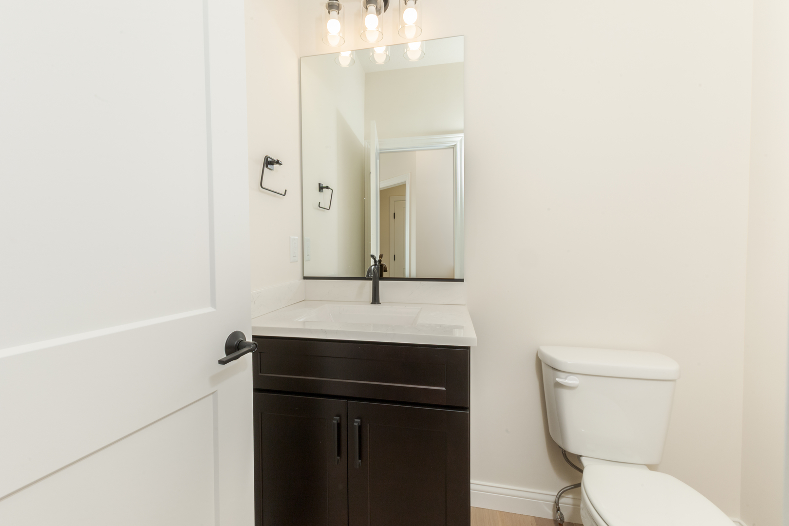 1313 Woodbine Road Bloomington, IL 61704 - Photo 8 of 67 a bathroom with a sink a toilet a mirror and shower