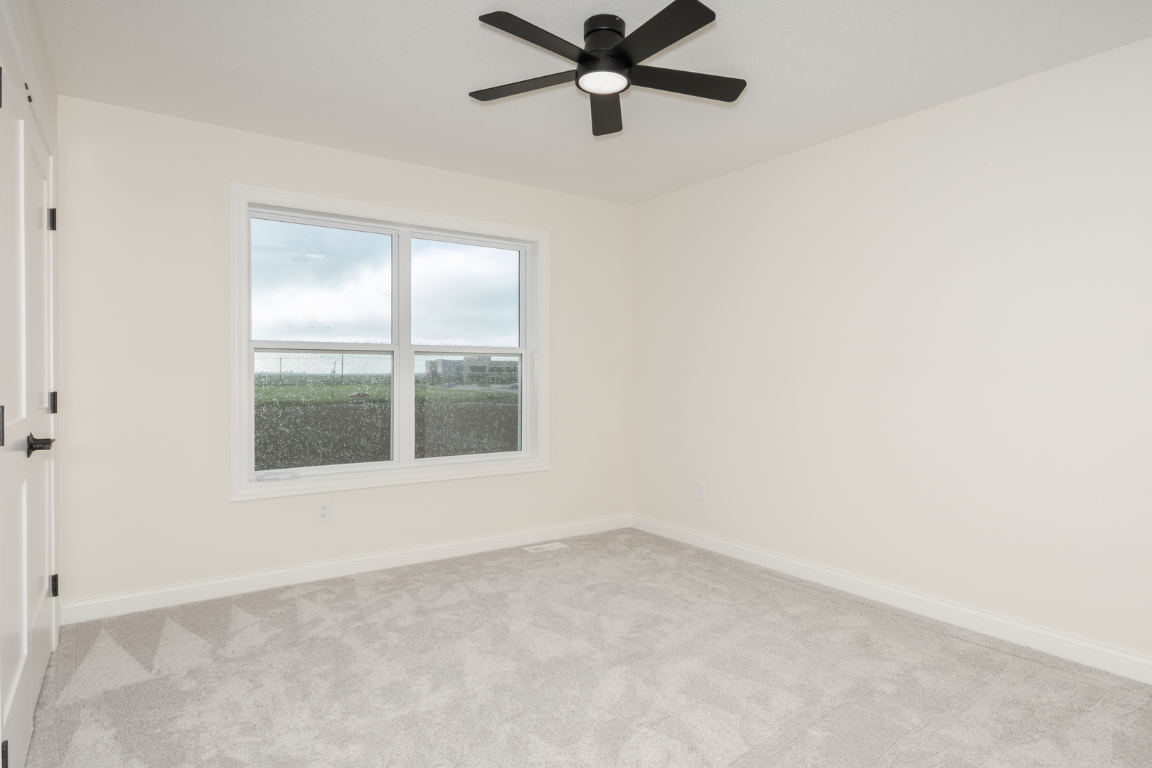 1313 Woodbine Road Bloomington, IL 61704 - Photo 10 of 67 an empty room with a window