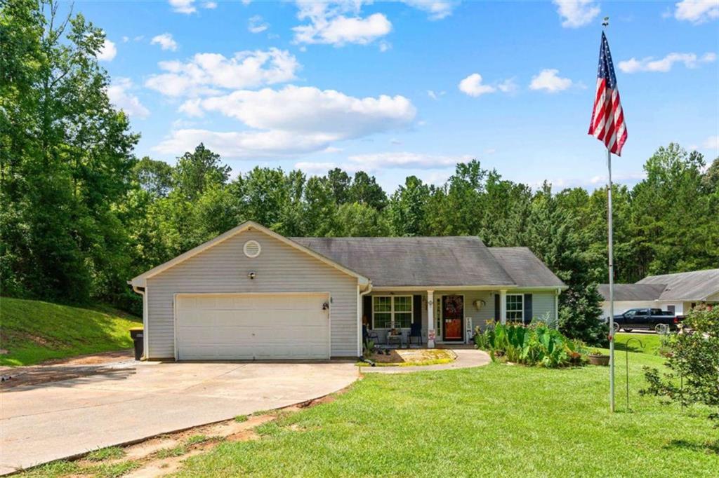 1055 Wagers Mill Road Newnan, GA 30263 - Photo 1 of 1 a house with trees in the background