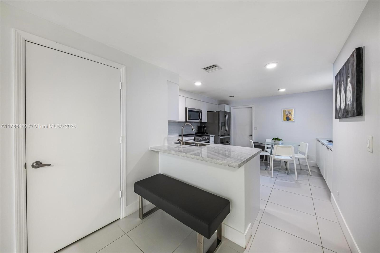 1524 Coronado Road, Unit 535 Fort Lauderdale, FL 33327 - Photo 13 of 54 a kitchen with a sink cabinets and stainless steel appliances