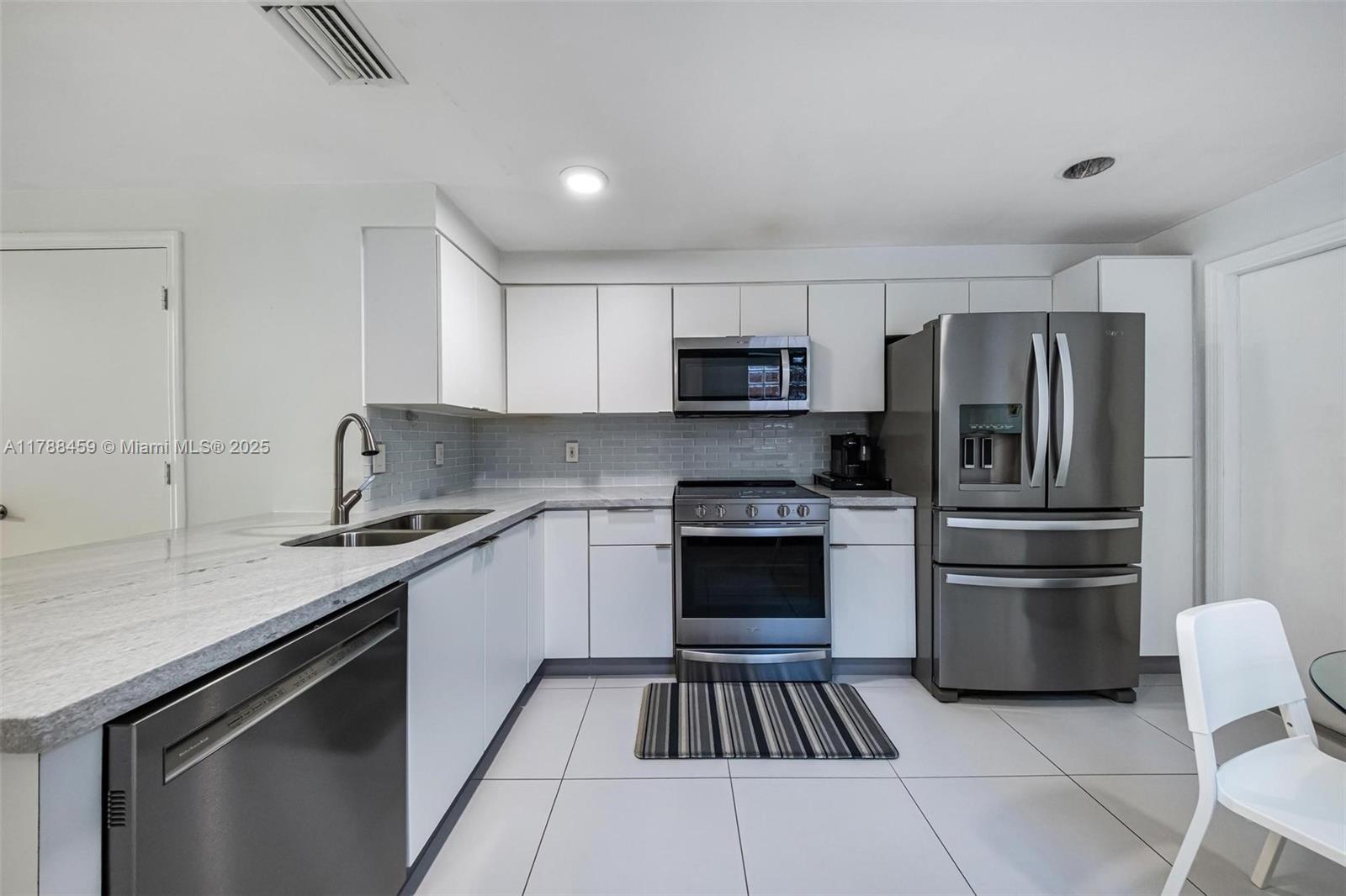 1524 Coronado Road, Unit 535 Fort Lauderdale, FL 33327 - Photo 14 of 54 a kitchen with a sink stove and refrigerator