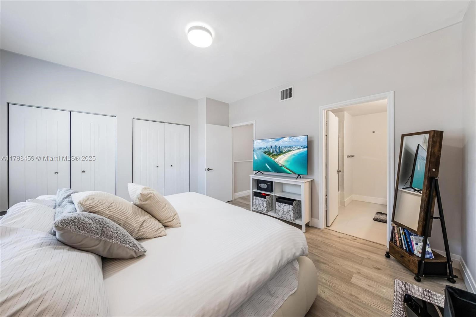 1524 Coronado Road, Unit 535 Fort Lauderdale, FL 33327 - Photo 25 of 54 a bedroom with a bed and a flat tv screen on a dresser