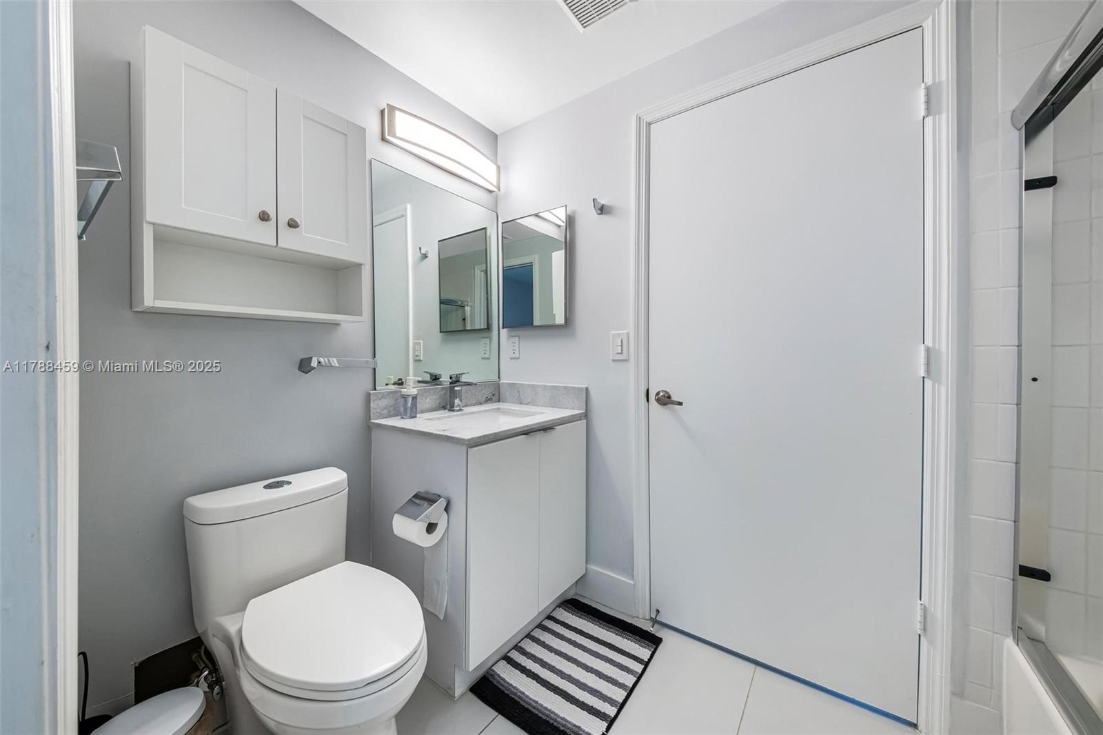 1524 Coronado Road, Unit 535 Fort Lauderdale, FL 33327 - Photo 33 of 54 a bathroom with a toilet a sink and mirror