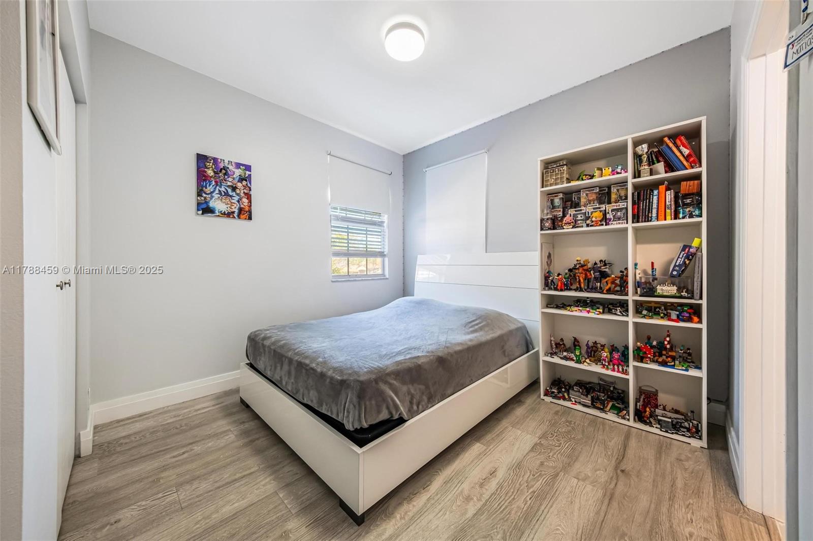1524 Coronado Road, Unit 535 Fort Lauderdale, FL 33327 - Photo 34 of 54 a bed room with a bed and a book shelf
