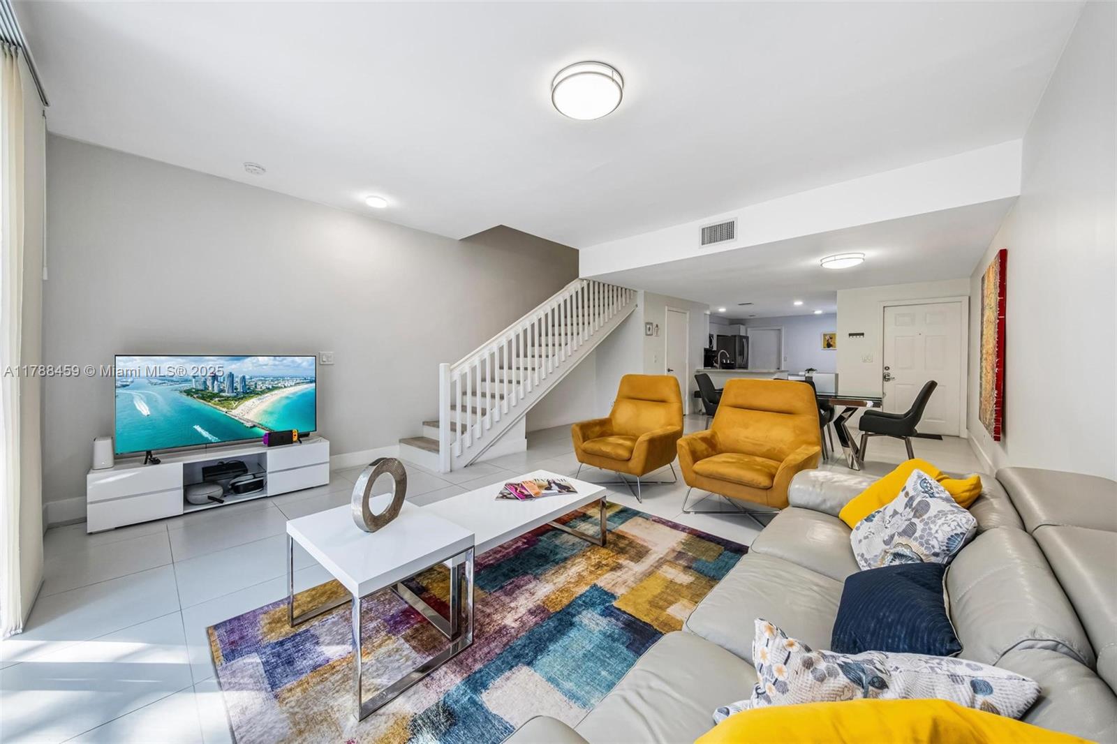 1524 Coronado Road, Unit 535 Fort Lauderdale, FL 33327 - Photo 7 of 54 a living room with furniture and a flat screen tv